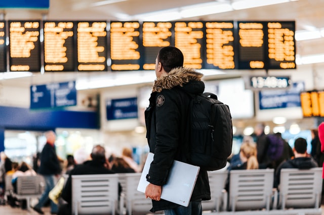 a picture showing a customer calling a long distance car service when connecting flight is canceled